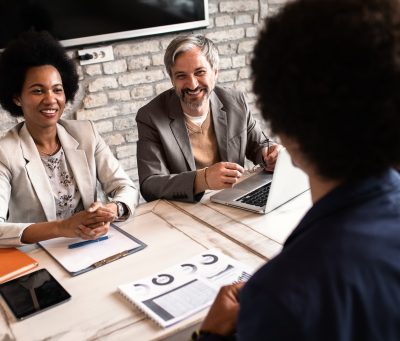 Business recruiters talking with candidate during job interview.